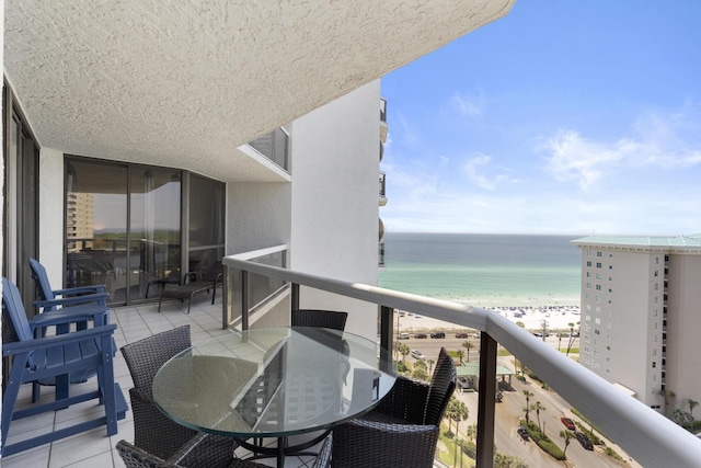 balcony with a water view and a beach view