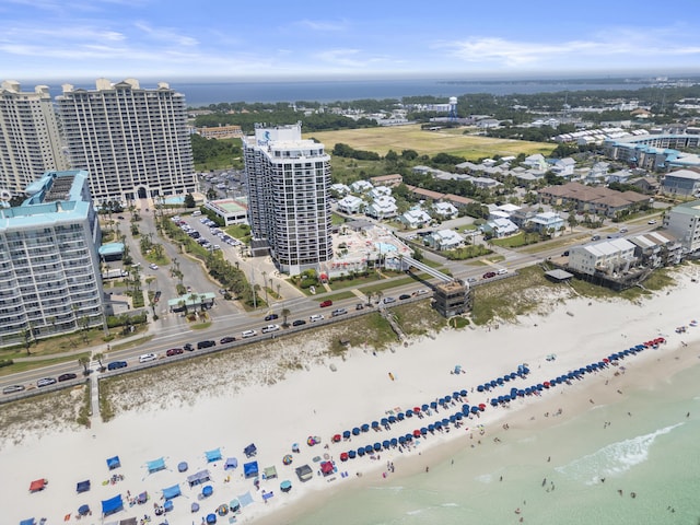 birds eye view of property featuring a beach view, a water view, and a city view