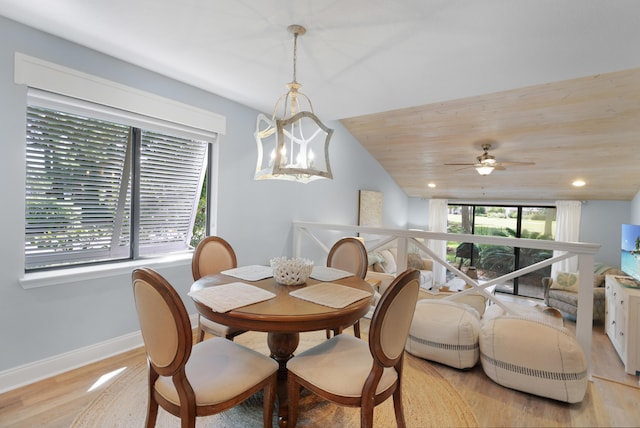 dining space featuring a healthy amount of sunlight, ceiling fan with notable chandelier, and light hardwood / wood-style floors