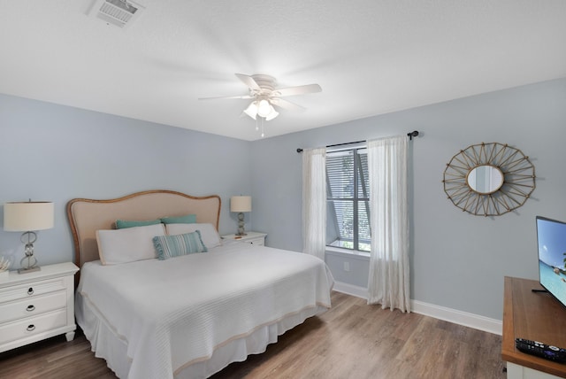 bedroom with hardwood / wood-style floors and ceiling fan