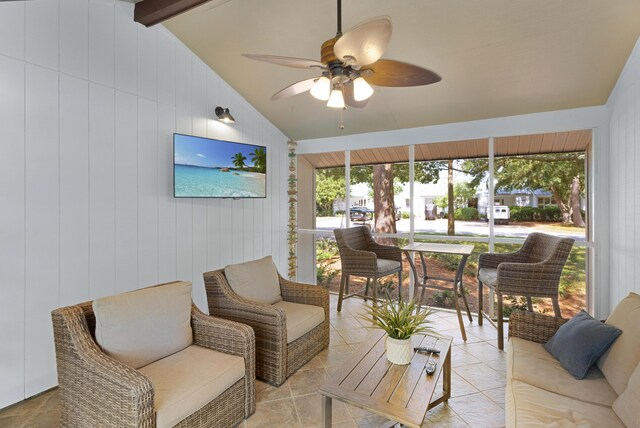 interior space with lofted ceiling with beams and ceiling fan