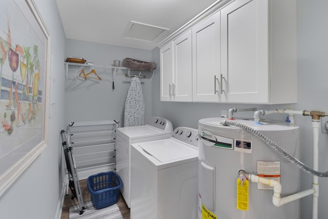 laundry area featuring washer and dryer, cabinets, water heater, and light hardwood / wood-style flooring