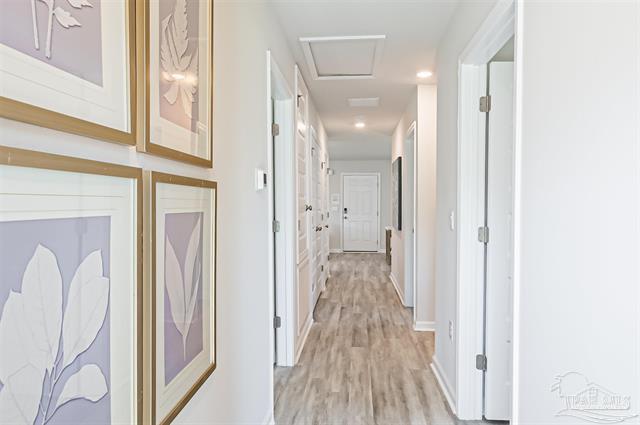 corridor with light hardwood / wood-style flooring