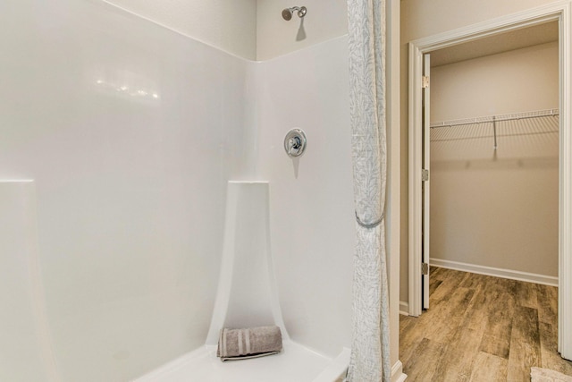 bathroom with a shower and hardwood / wood-style flooring