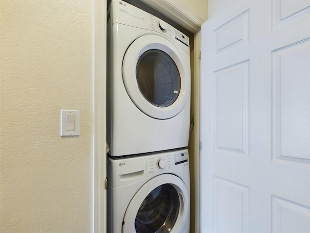 790 Santa Rosa Blvd Unit 3009, Fort Walton Beach, FL 32548 - washroom featuring stacked washer and dryer, a textured wall, and laundry area
