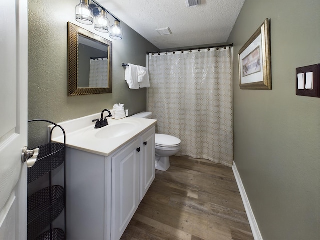 790 Santa Rosa Blvd Unit 3009, Fort Walton Beach, FL 32548 - bathroom with a textured ceiling, baseboards, wood finished floors, toilet, and vanity