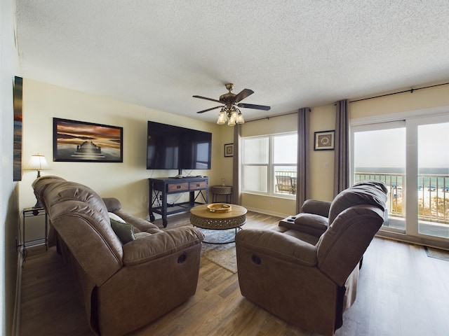 790 Santa Rosa Blvd Unit 3009, Fort Walton Beach, FL 32548 - living room featuring a ceiling fan, a textured ceiling, baseboards, and wood finished floors