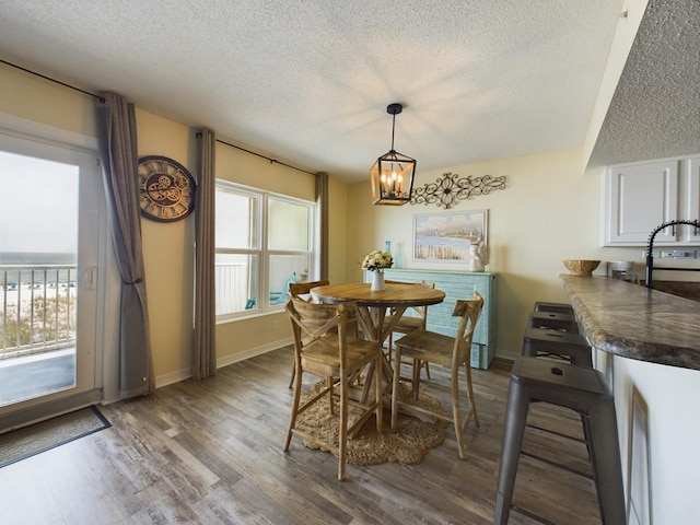 790 Santa Rosa Blvd Unit 3009, Fort Walton Beach, FL 32548 - dining area featuring baseboards, a textured ceiling, wood finished floors, and a chandelier