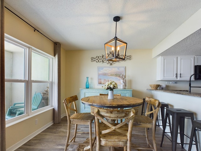 790 Santa Rosa Blvd Unit 3009, Fort Walton Beach, FL 32548 - dining space featuring baseboards, a textured ceiling, wood finished floors, and a chandelier