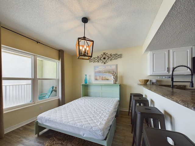 790 Santa Rosa Blvd Unit 3009, Fort Walton Beach, FL 32548 - bedroom featuring baseboards, a textured ceiling, a notable chandelier, and dark wood finished floors