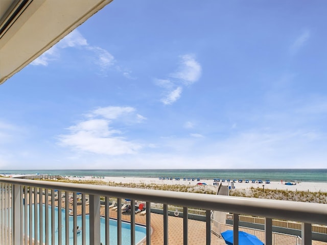 balcony with a view of the beach and a water view