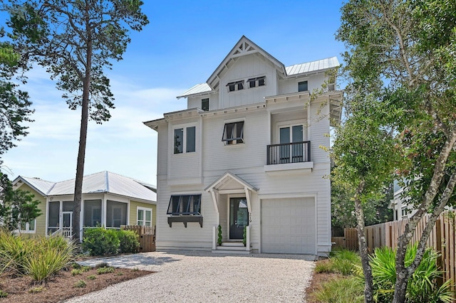 view of front of home with a garage and a balcony