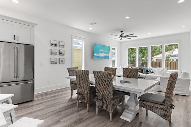 dining room with plenty of natural light, ceiling fan, and light hardwood / wood-style floors