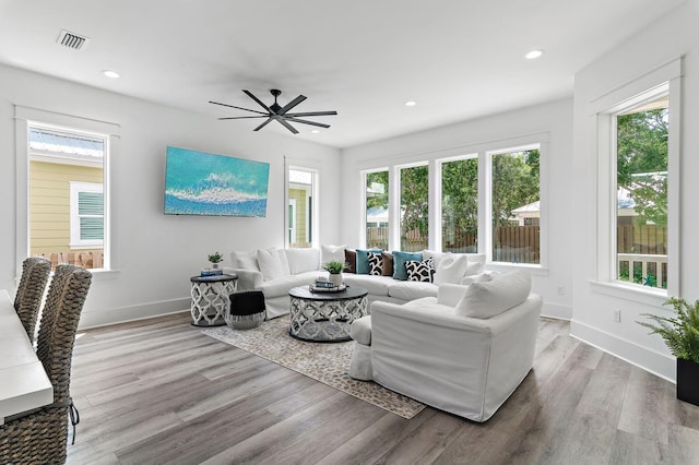 living room featuring ceiling fan and light hardwood / wood-style floors