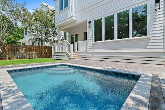 view of swimming pool featuring a deck