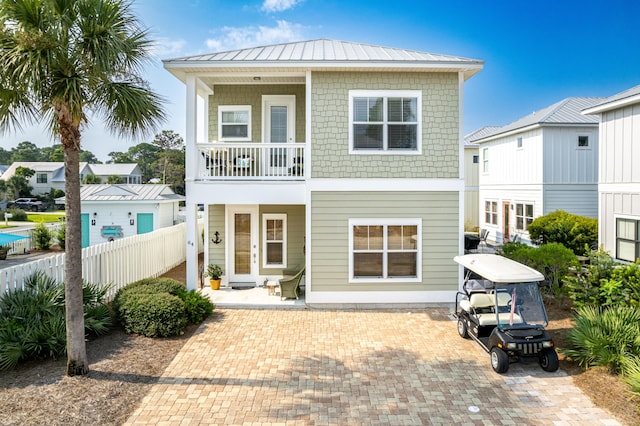 back of house featuring a balcony