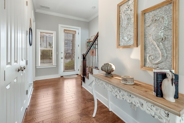 foyer featuring ornamental molding and wood-type flooring