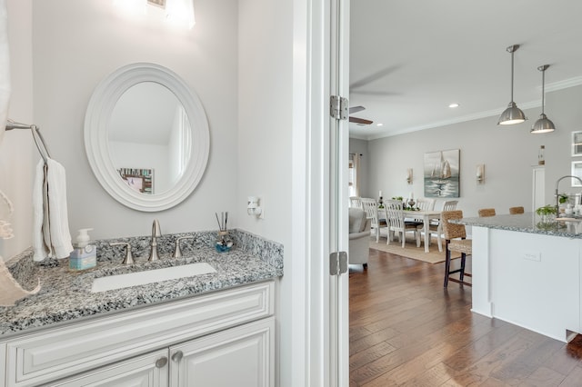 bathroom featuring ceiling fan, vanity, hardwood / wood-style floors, and crown molding