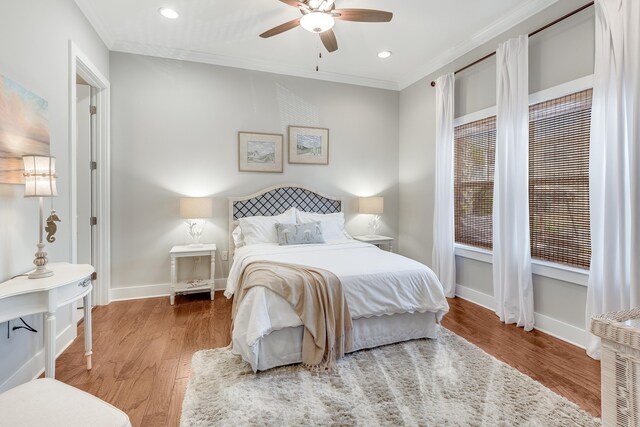 bedroom featuring ornamental molding, hardwood / wood-style floors, and ceiling fan