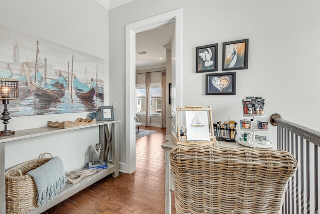 interior space featuring hardwood / wood-style floors and crown molding