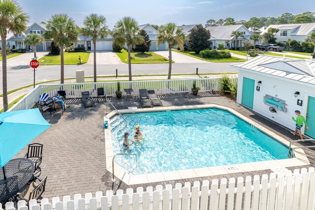 view of pool featuring a lawn