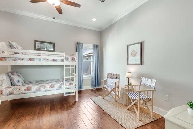 bedroom featuring ceiling fan, ornamental molding, and hardwood / wood-style floors