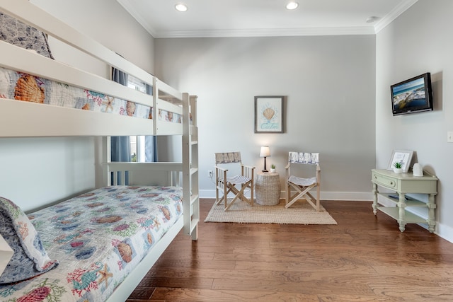 bedroom featuring hardwood / wood-style floors and crown molding