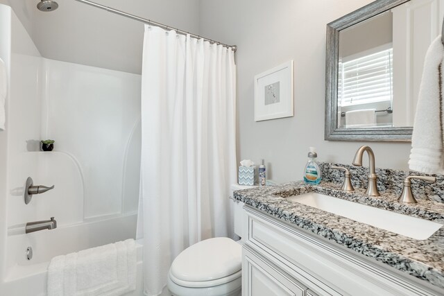 full bathroom featuring shower / bath combo, toilet, and vanity