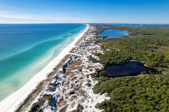 bird's eye view featuring a water view and a beach view