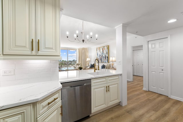 kitchen featuring sink, backsplash, light stone counters, cream cabinetry, and stainless steel dishwasher