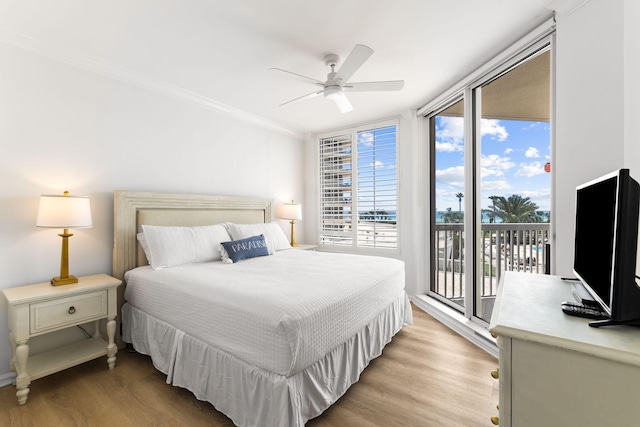 bedroom featuring access to outside, ceiling fan, floor to ceiling windows, crown molding, and light wood-type flooring