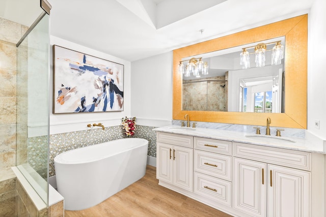 bathroom featuring vanity, shower with separate bathtub, and hardwood / wood-style floors