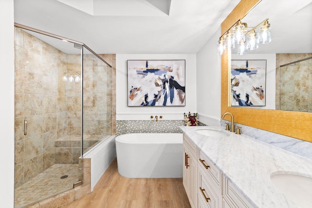 bathroom featuring hardwood / wood-style floors, independent shower and bath, and vanity