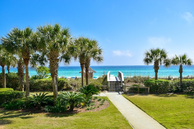 surrounding community with a lawn and a water view