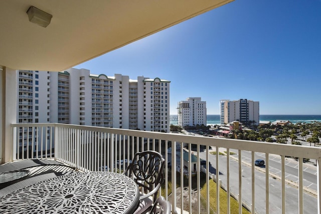 balcony featuring a water view and a city view