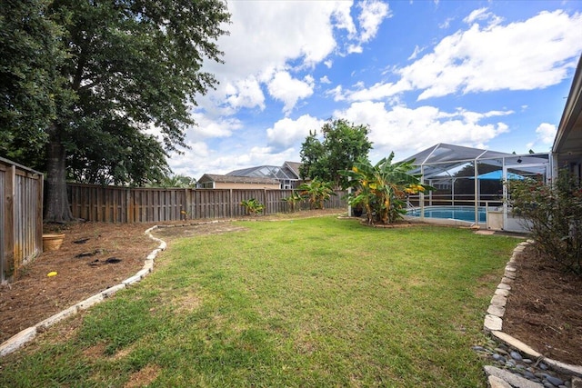 view of yard featuring glass enclosure and a fenced in pool