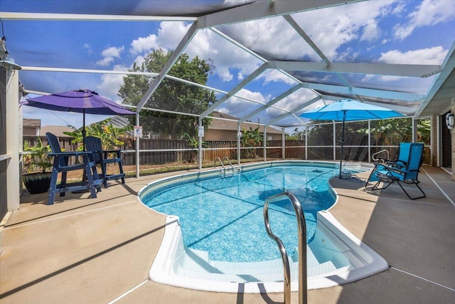 view of swimming pool with a patio and a lanai