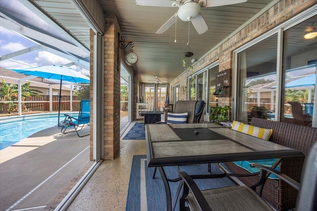 sunroom / solarium featuring ceiling fan