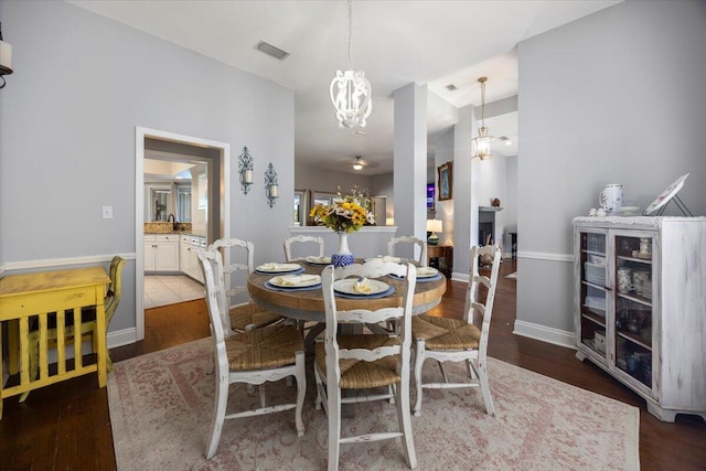 dining room featuring dark tile patterned flooring and an inviting chandelier