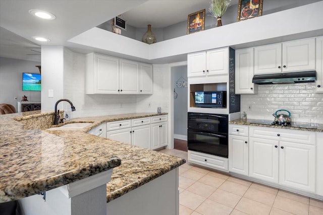 kitchen with kitchen peninsula, light tile patterned floors, sink, and black appliances