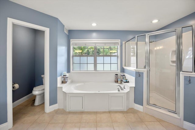 bathroom with tile patterned floors, shower with separate bathtub, and toilet