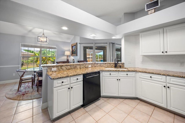 kitchen featuring light stone counters, white cabinetry, dishwasher, and plenty of natural light