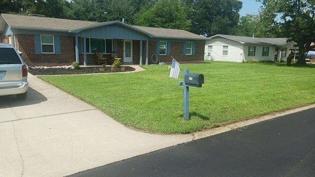 single story home with a front lawn and brick siding