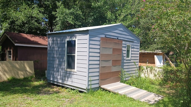 view of shed with fence