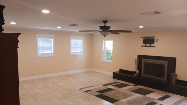 unfurnished living room featuring a fireplace, recessed lighting, baseboards, and visible vents