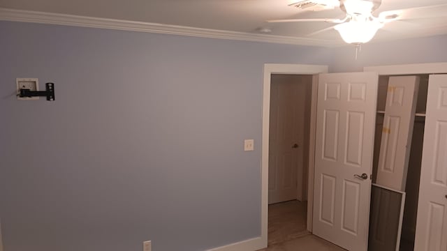 unfurnished bedroom with a closet, visible vents, baseboards, and ornamental molding