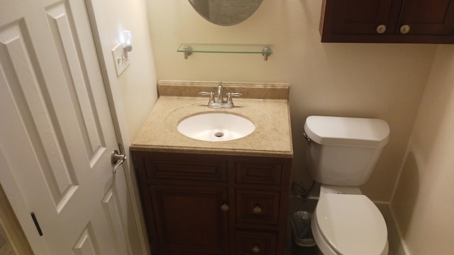 bathroom featuring toilet and vanity