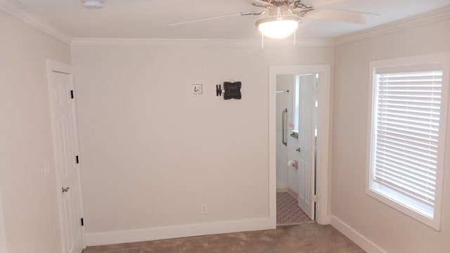 carpeted spare room featuring ceiling fan, baseboards, and ornamental molding