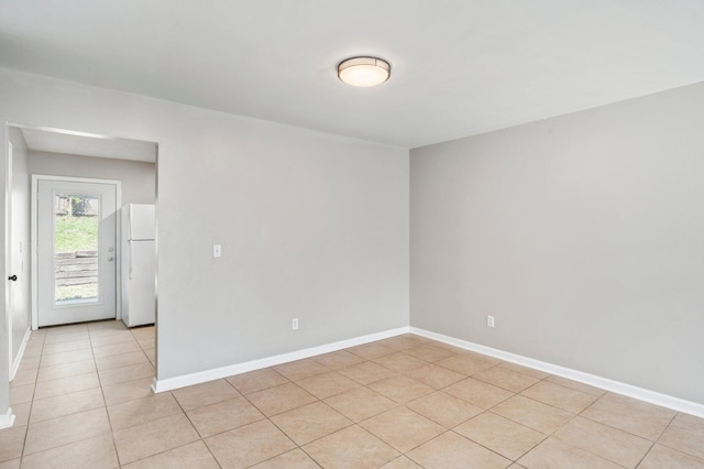 spare room featuring light tile patterned flooring