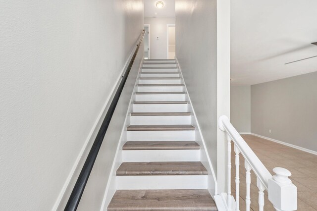 stairs featuring tile patterned floors